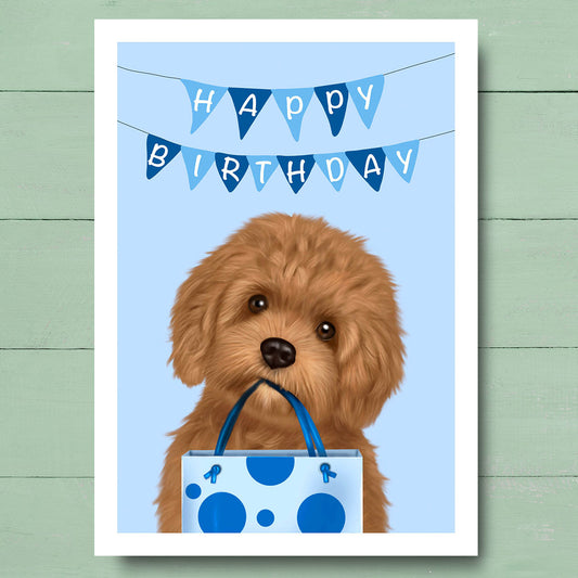 Birthday card with Cavapoo holding Blue gift bag