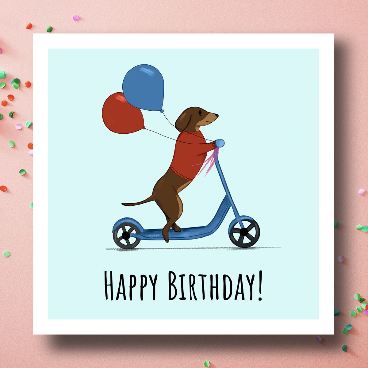 Birthday card with Dachshund on a scooter holding balloons