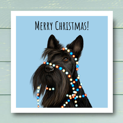 Scottish Terrier wrapped in Christmas tree lights. Christmas Card illustrated by Oundle artist Kitty's Art.