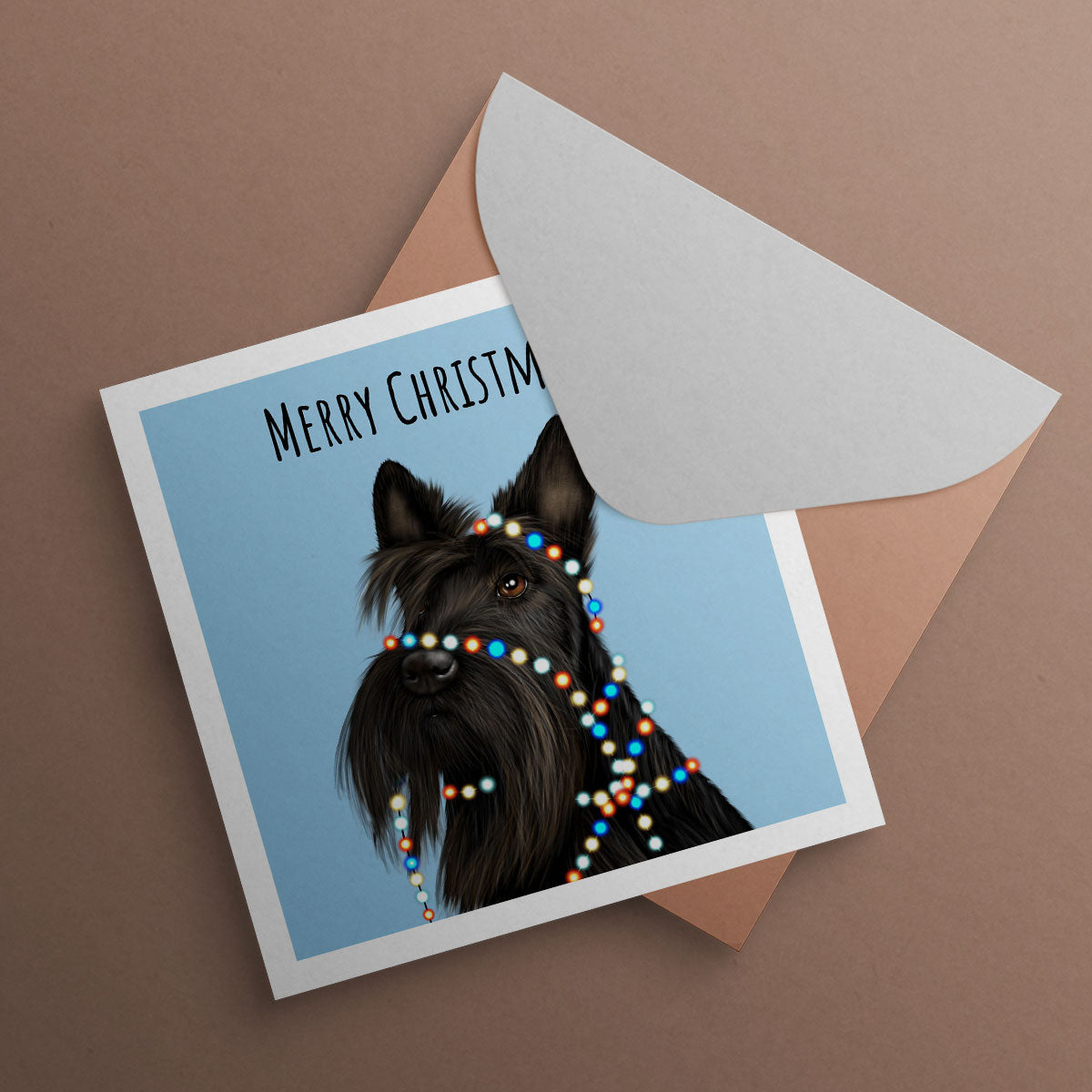 Scottish Terrier wrapped in Christmas tree lights. Christmas Card illustrated by Oundle artist Kitty's Art.