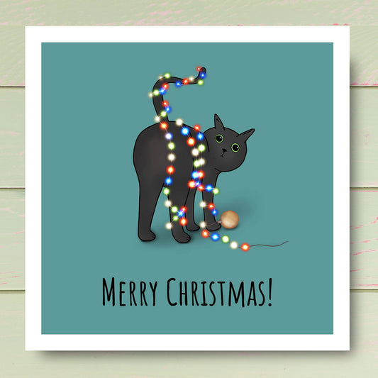 Funny illustrated Black cat with Christmas decorations wrapped around it. Christmas card illustrated by Oundle Artist Kitty's Art